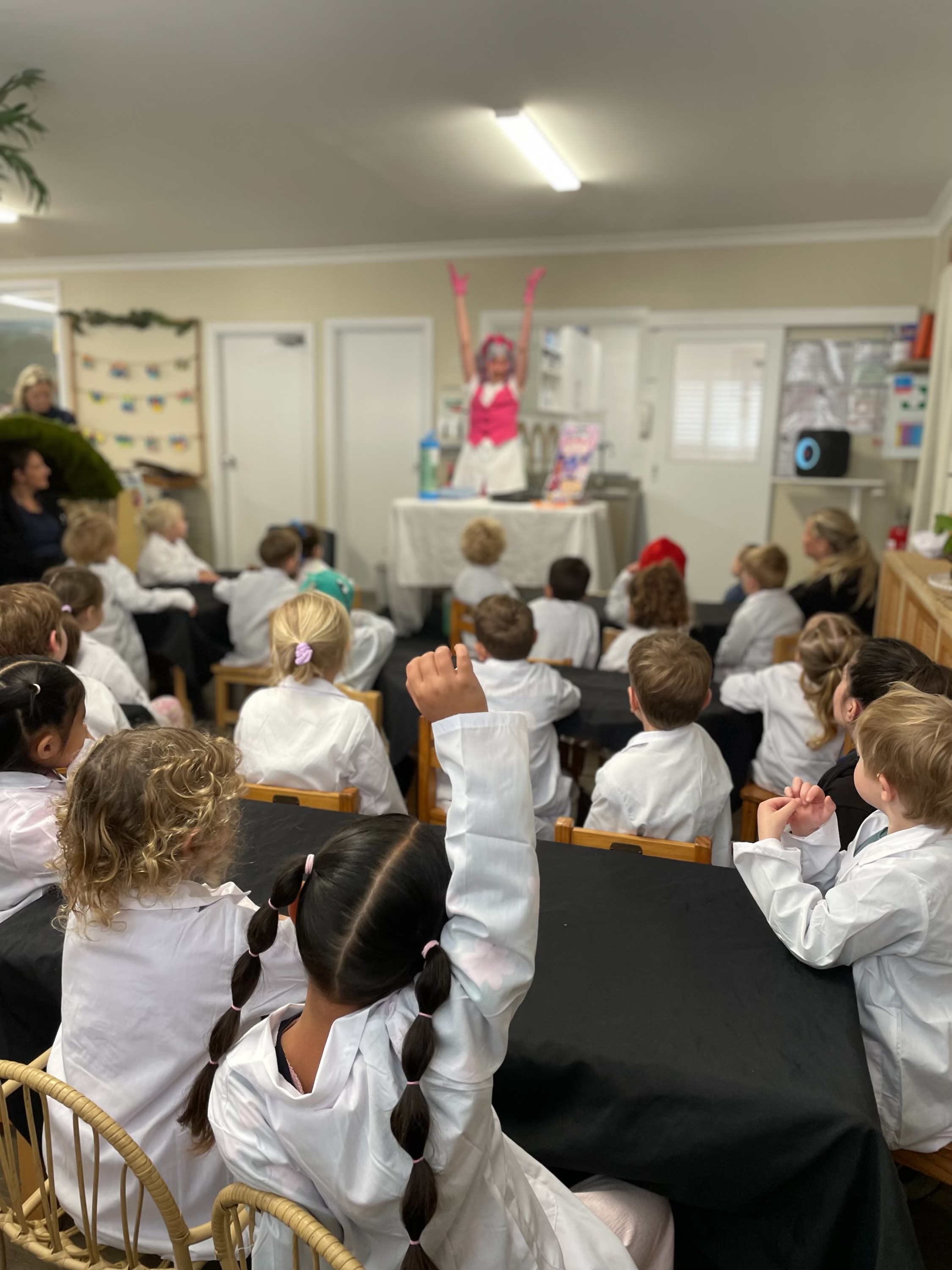 Lakeview Preschool children wearing laboratory coats and participating in Professor Pop’s Bubble Lab
